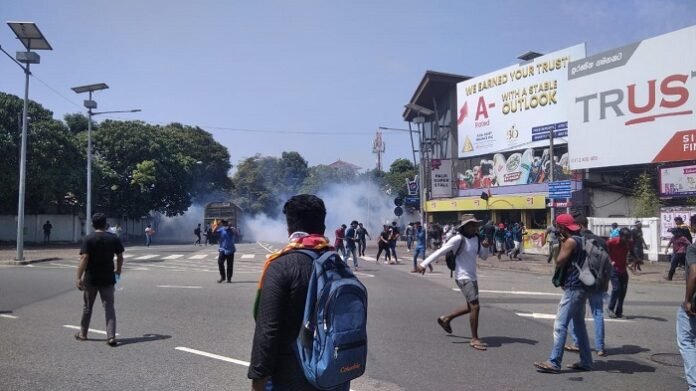 Police fire tear gas at protestors near the PM's Office.